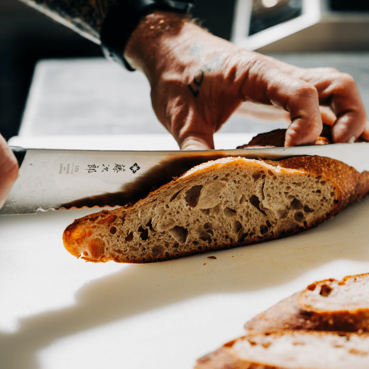 Chef slicing fresh made bread