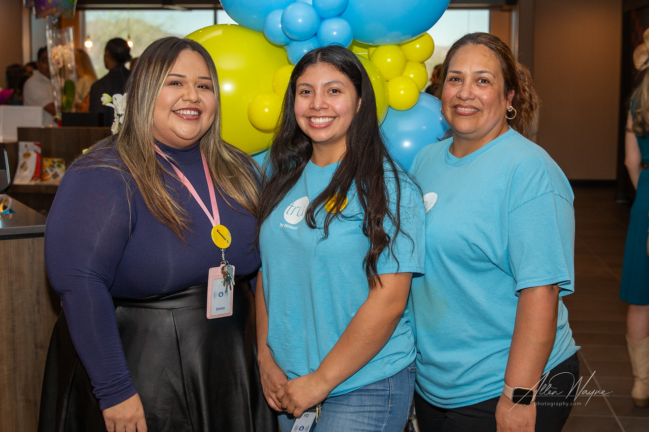Three female hotel professional smiling in the lobby